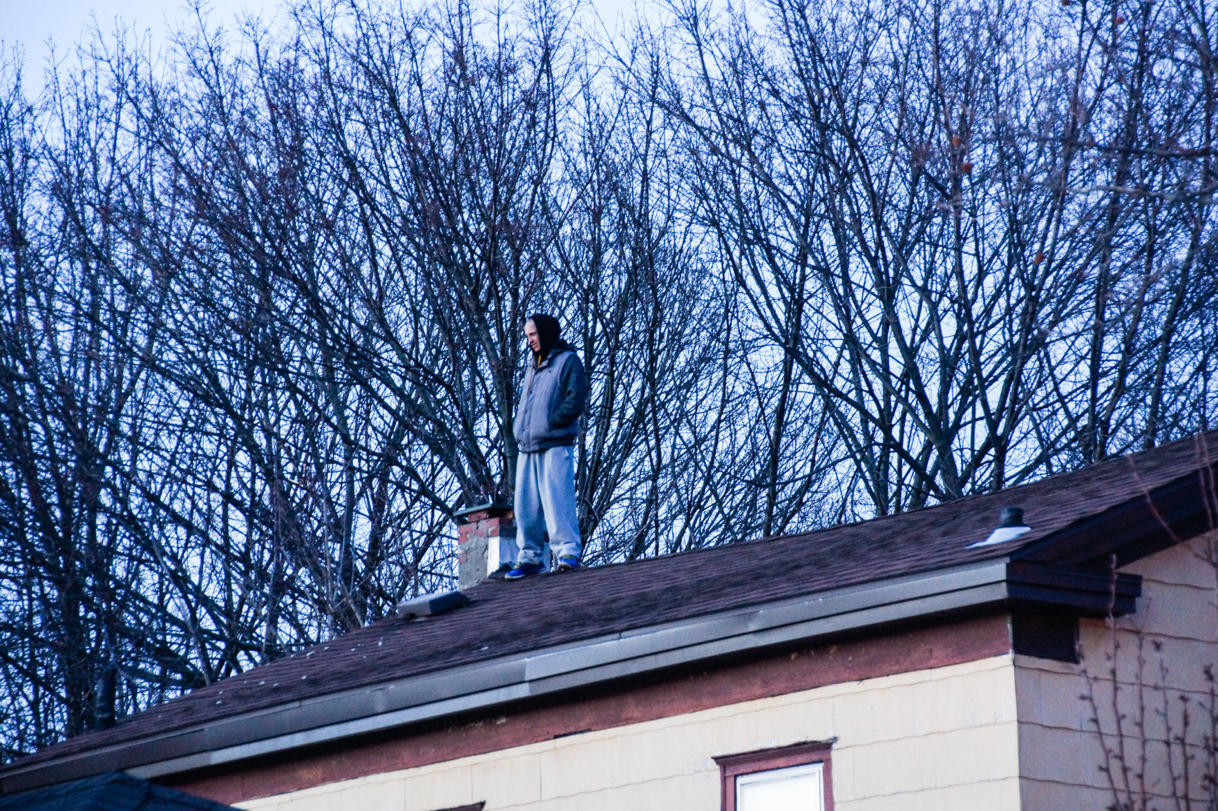 Man on roof of 51 Orchard St.